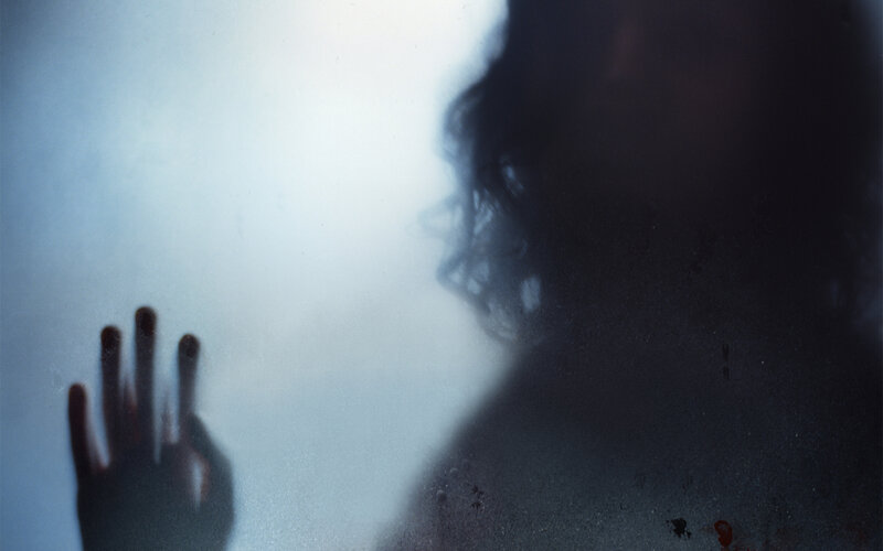 silhouette behind frosted glass