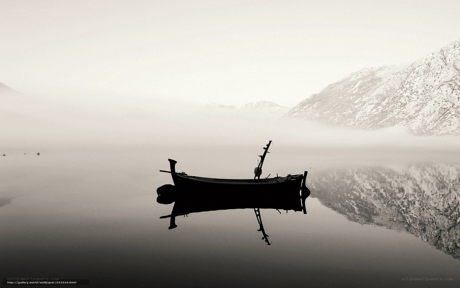 Silhouette boat on misty lake