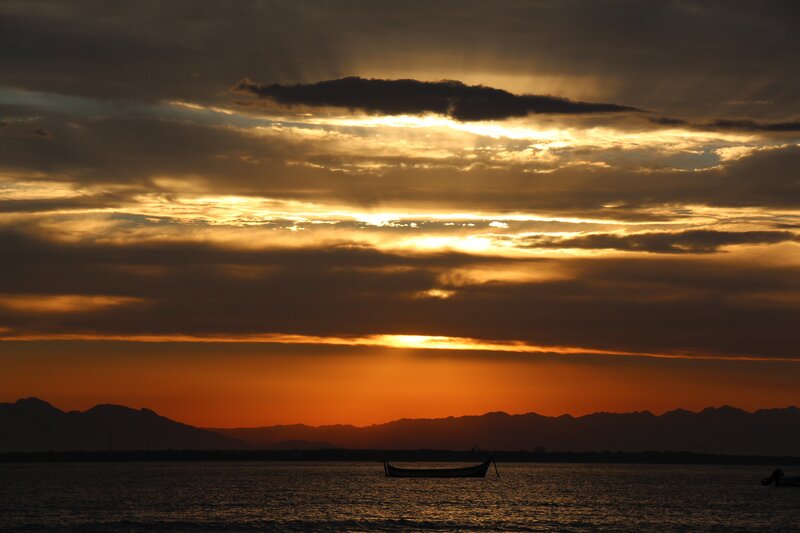 Silhouette Boat on Water — Orange, Dramatic