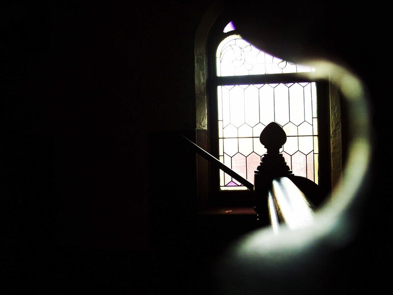 silhouette by stained glass window