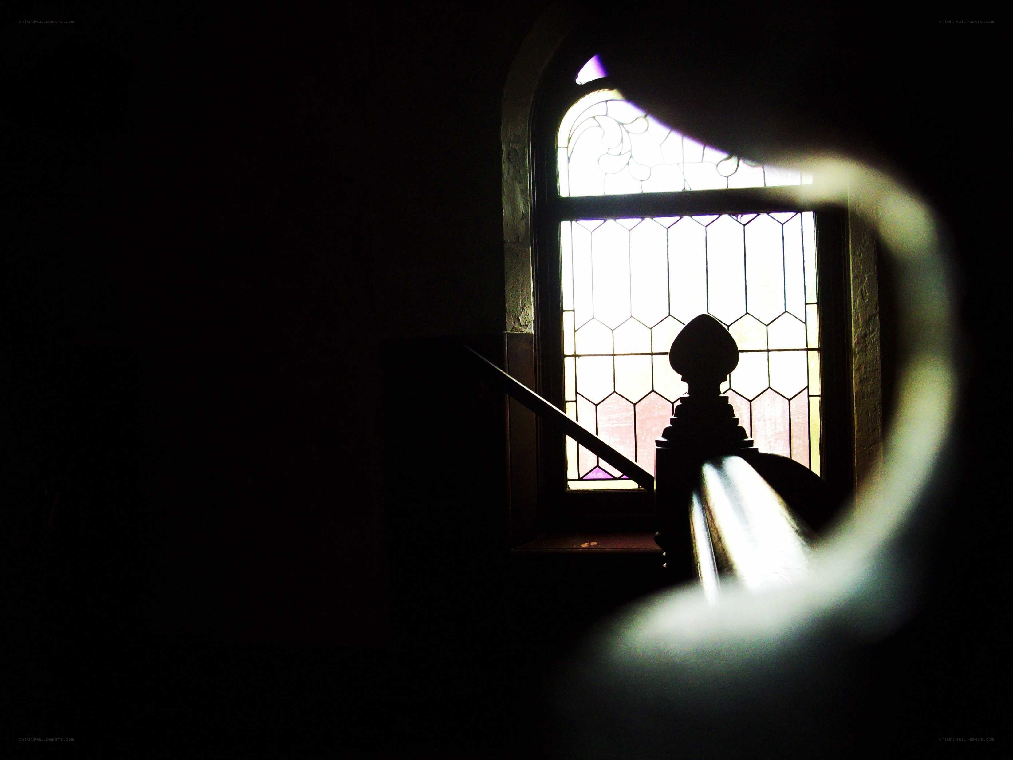 silhouette by stained glass window