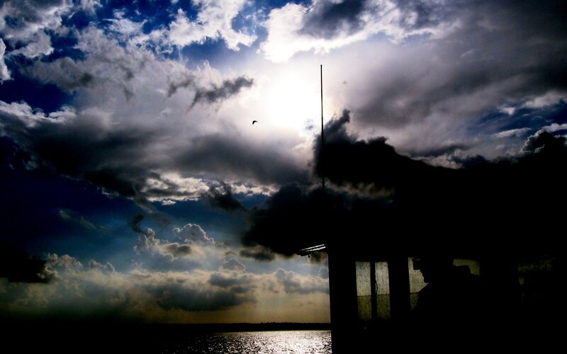 Silhouette by the water