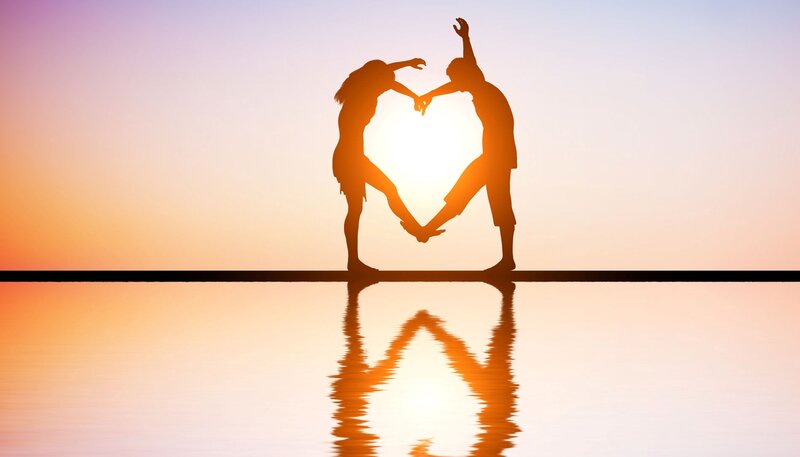 Silhouette Couple Forming Heart