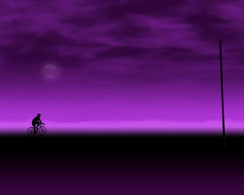 Silhouette cyclist at purple dusk