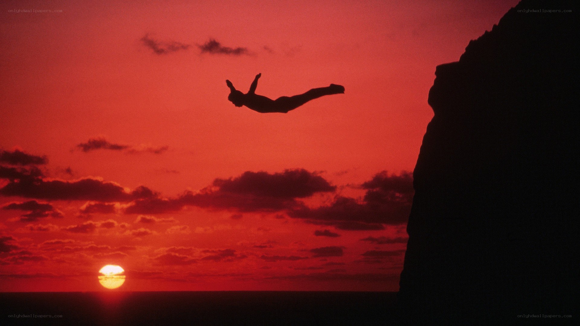 Silhouette diver at sunset