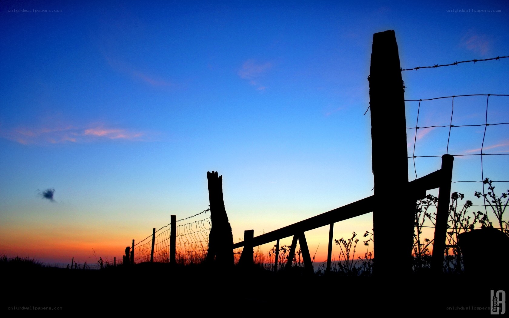 Silhouette fence at sunset