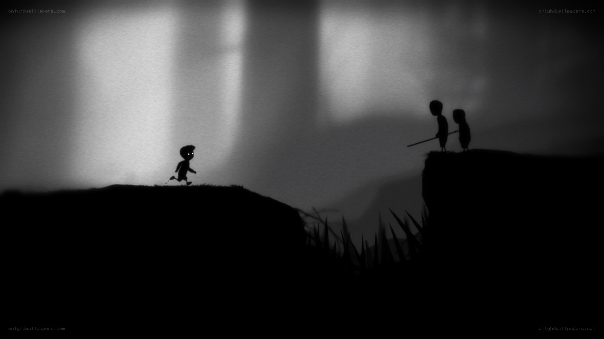 Silhouette figures on a cliff