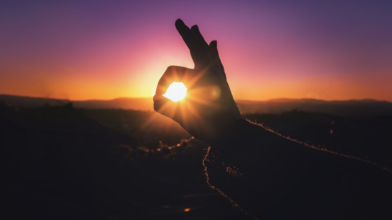 Silhouette Hand Holding Sun — Purple