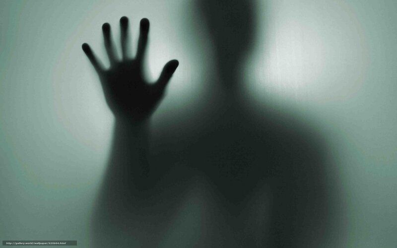 Silhouette hand on glass