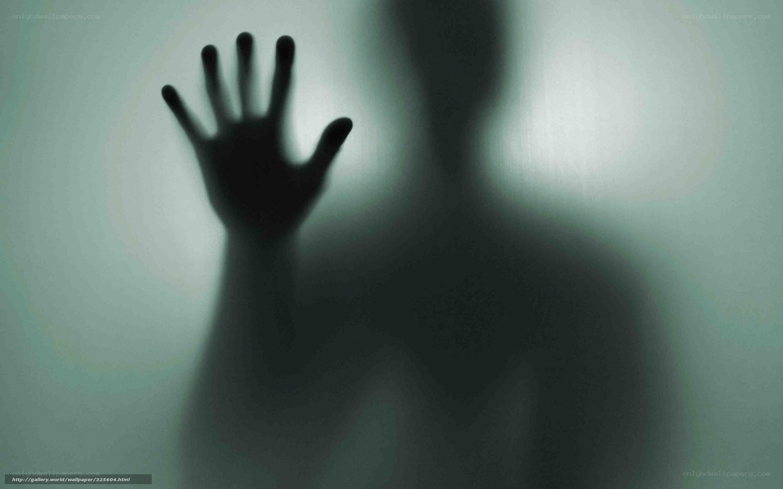 Silhouette hand on glass