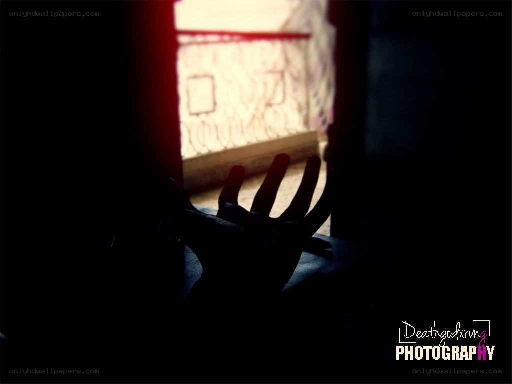 silhouette hand reaching for light
