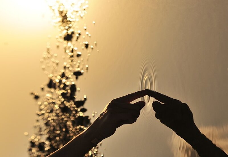 Silhouette Hands Making Ripples