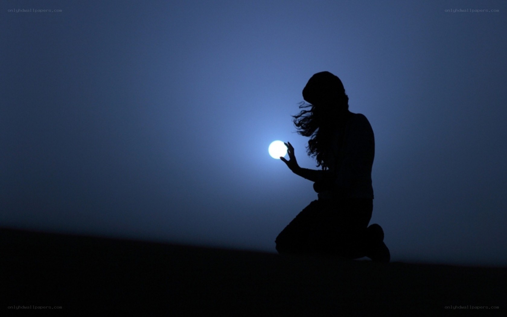 silhouette holding glowing orb