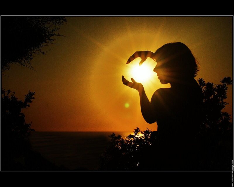 Silhouette Holding Sun — Orange, Dramatic