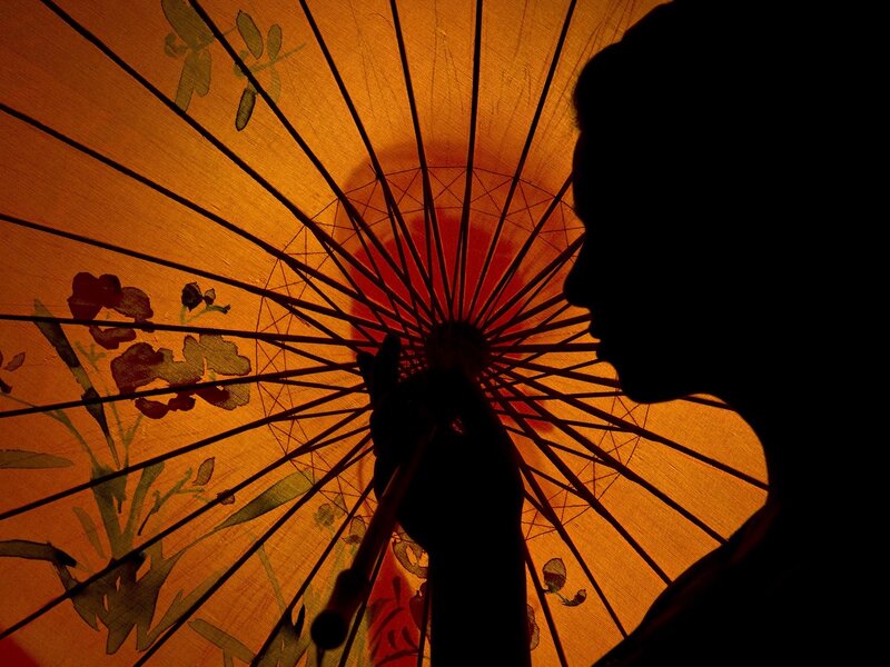 Silhouette Holding Umbrella — Orange, Dramatic