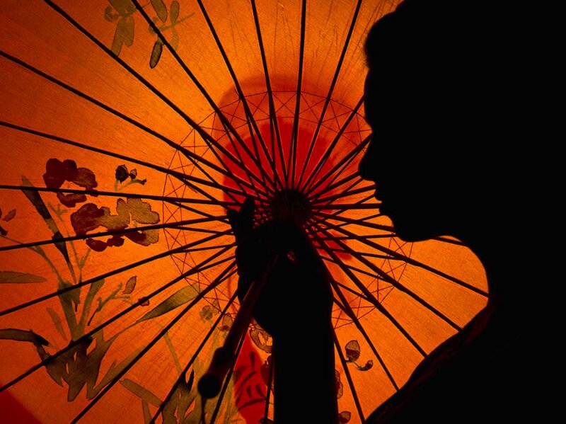 Silhouette Holding Umbrella — Orange