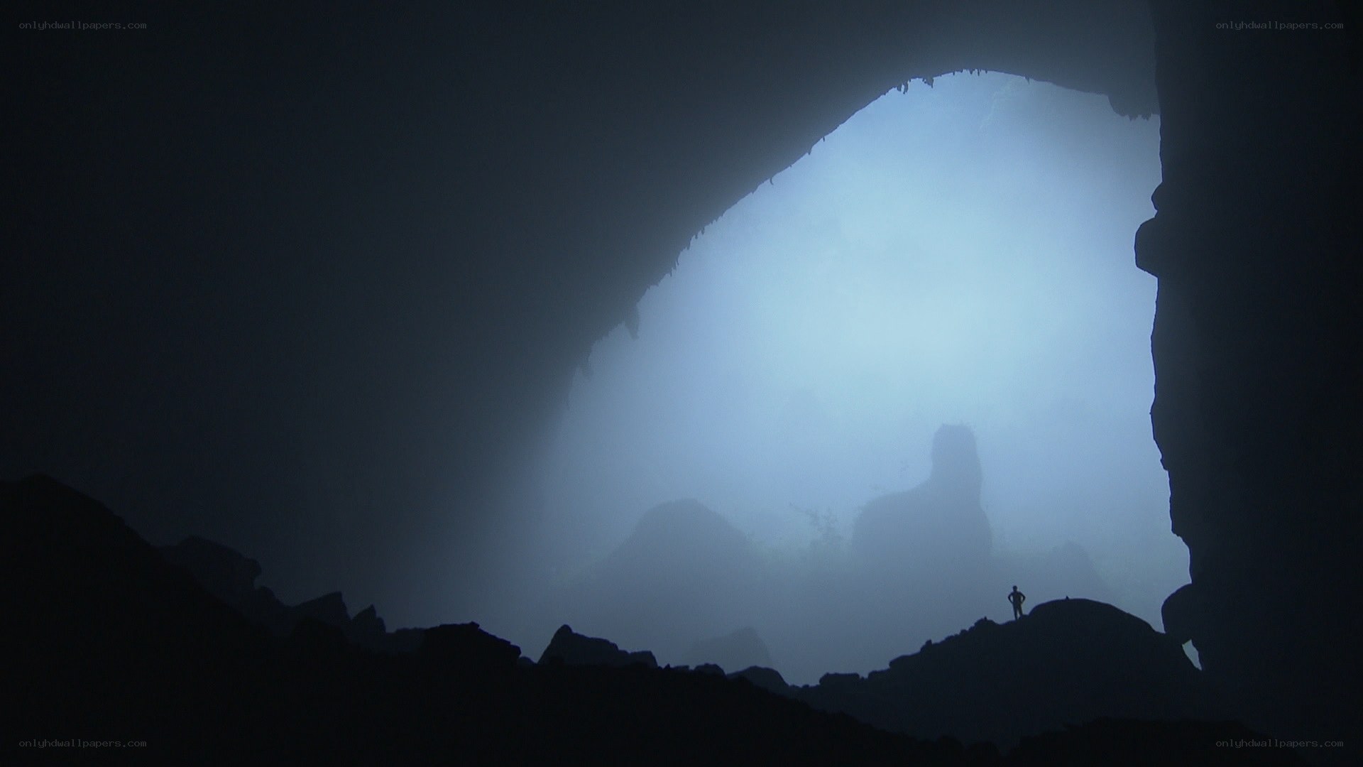 Silhouette in a misty cave