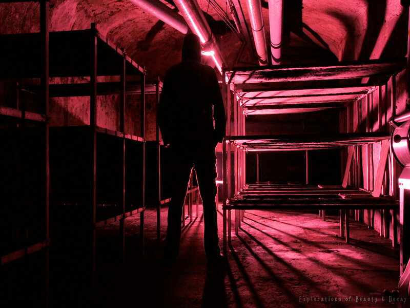 Silhouette in a red-lit bunker