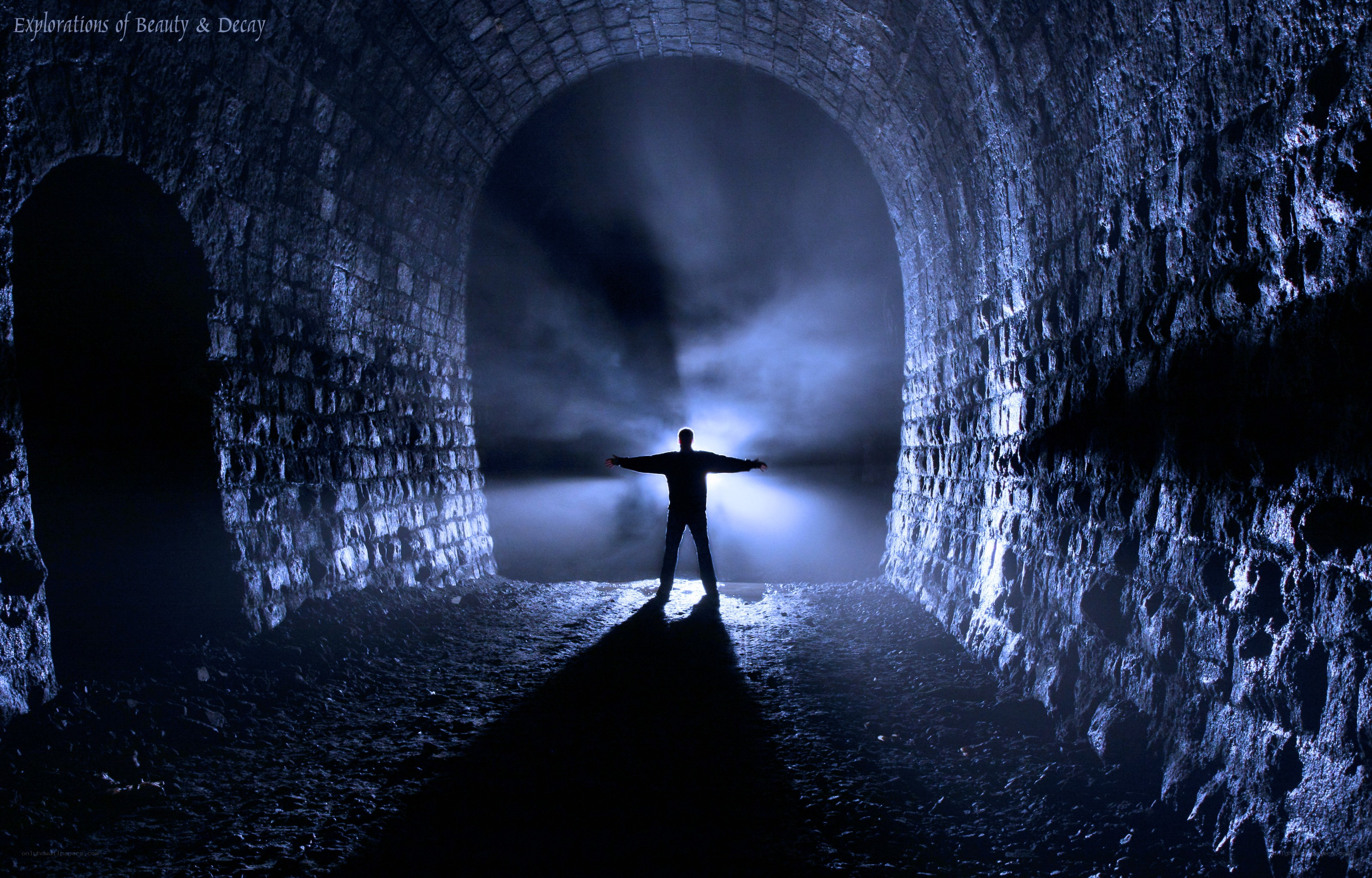 Silhouette in a stone tunnel