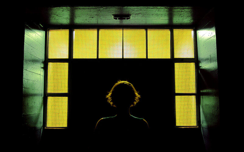silhouette in a yellow-lit room