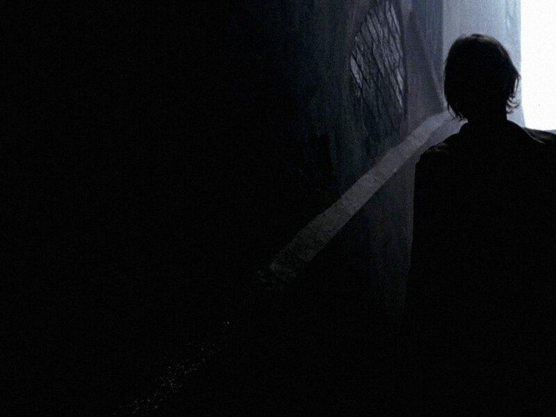 silhouette in dark corridor