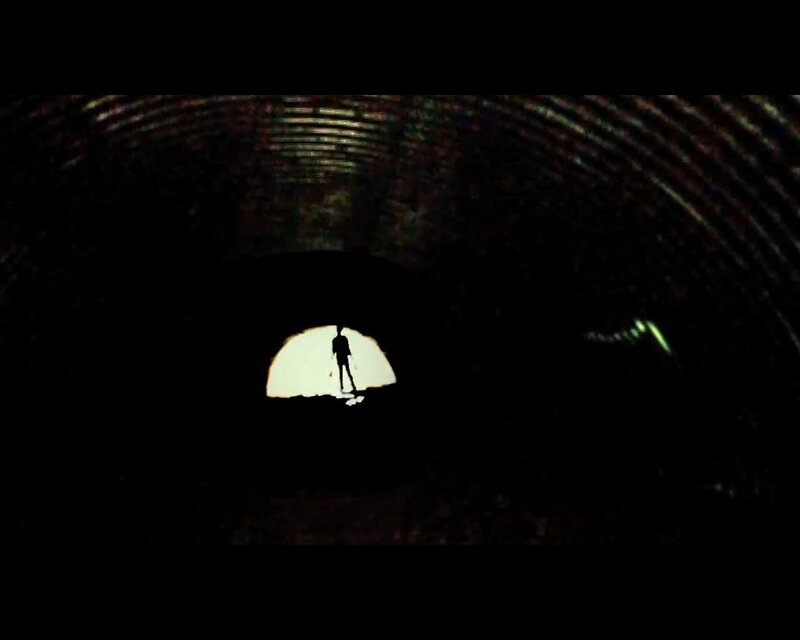 silhouette in dark tunnel