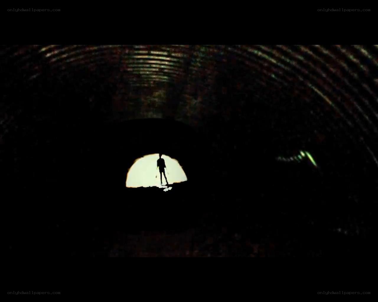 silhouette in dark tunnel