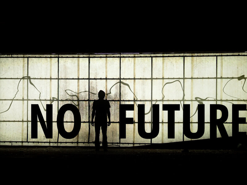 Silhouette in front of 'No Future' sign