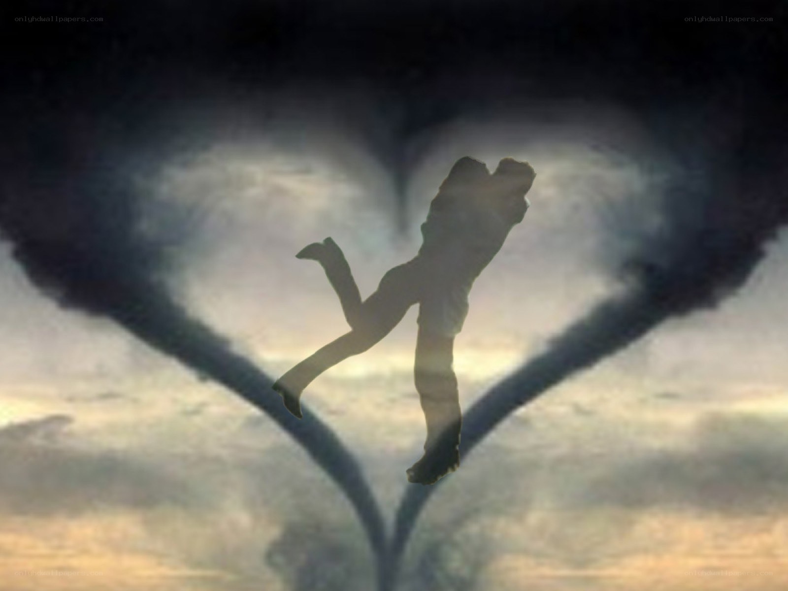 silhouette in heart-shaped clouds