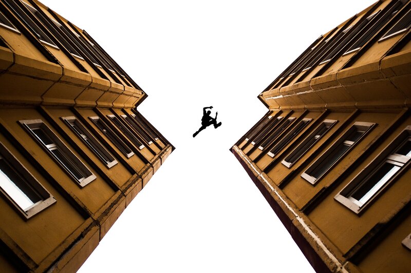 Silhouette Jumping Between Buildings