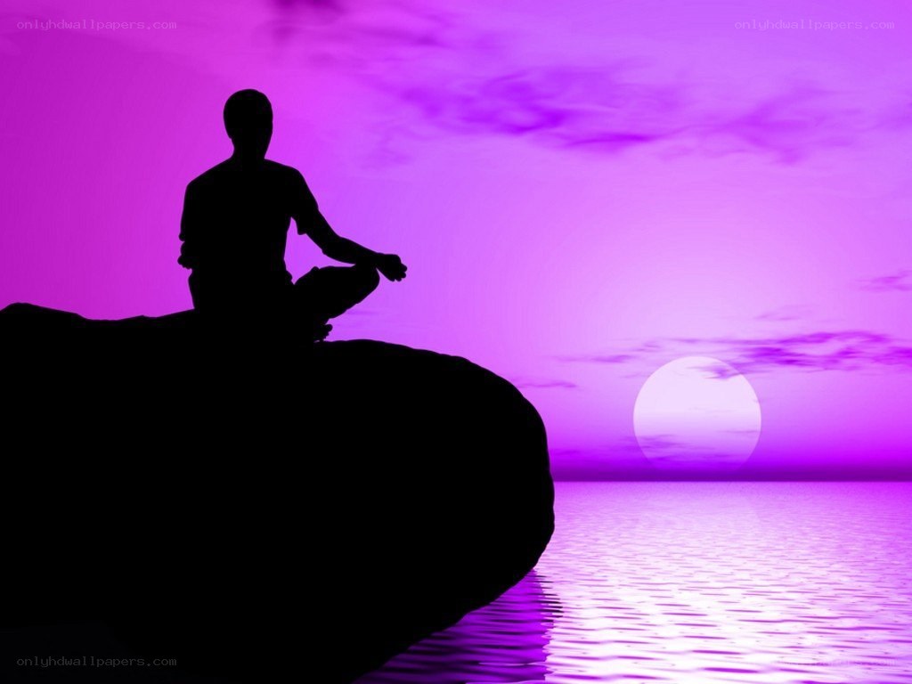 Silhouette meditating at sunset