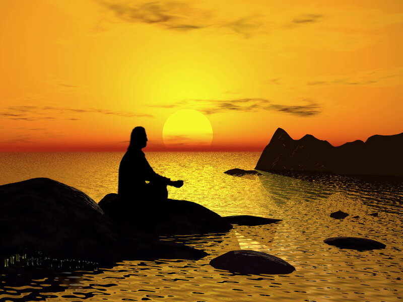 Silhouette Meditating on Rock