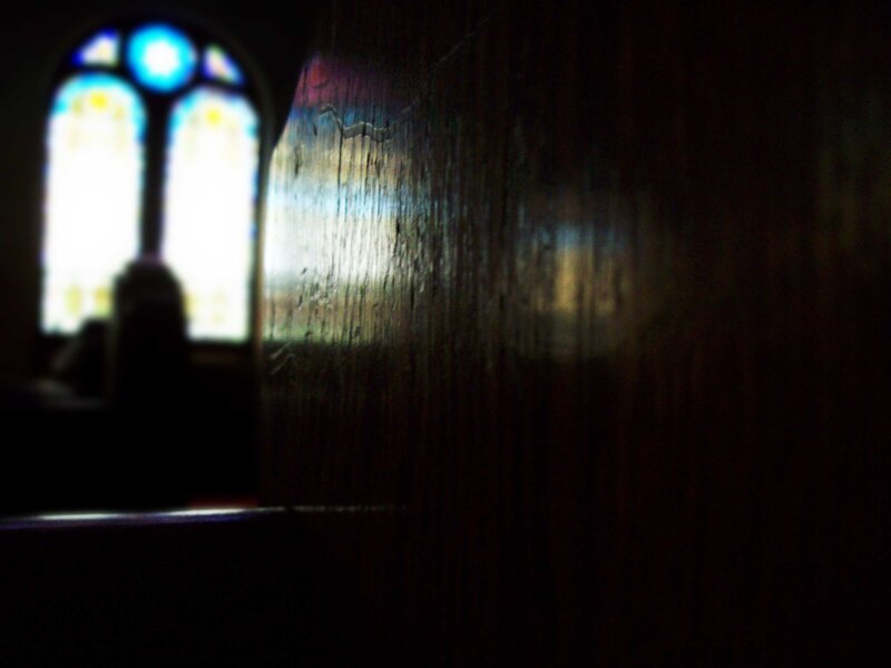 silhouette near stained glass window