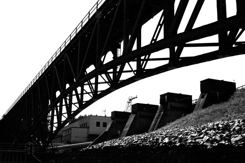 silhouette of a bridge and dam