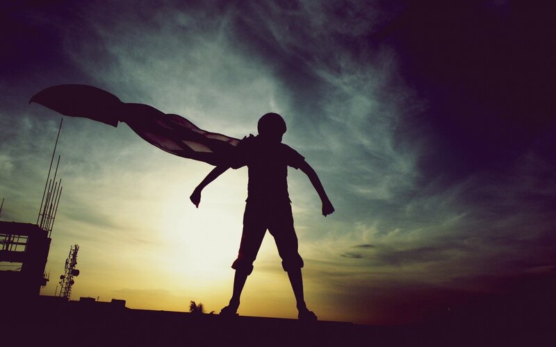 Silhouette of a child with cape