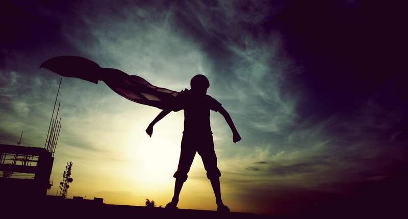 Silhouette of a child with cape