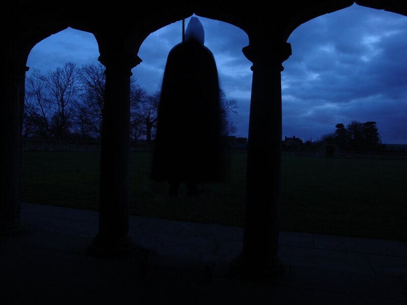 Silhouette of a cloaked figure