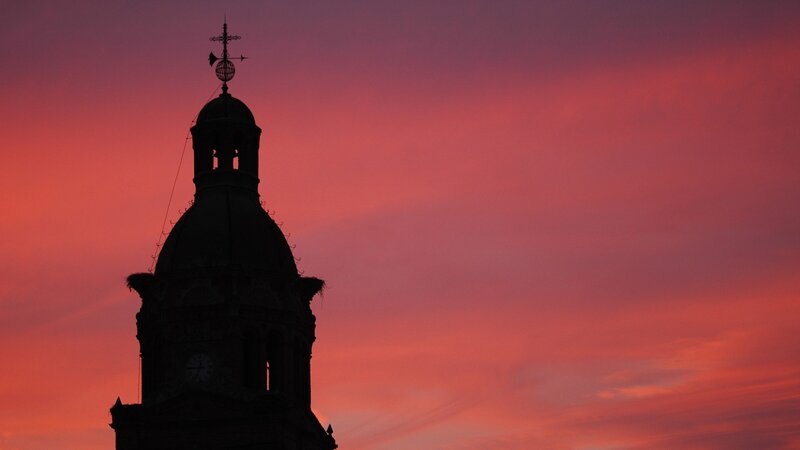 silhouette of a clock tower at sunset
