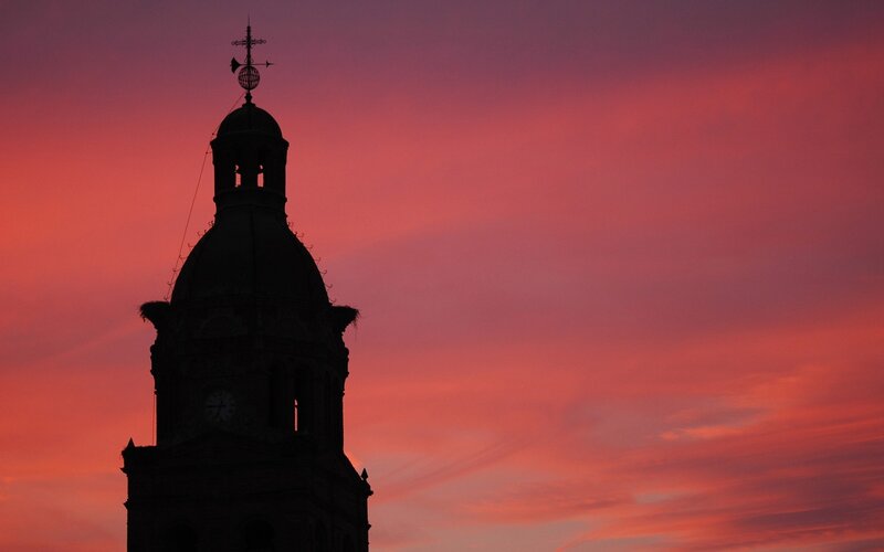 silhouette of a clock tower at sunset