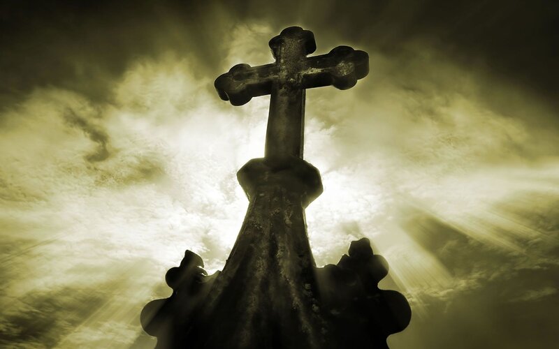 Silhouette of a cross at sunset