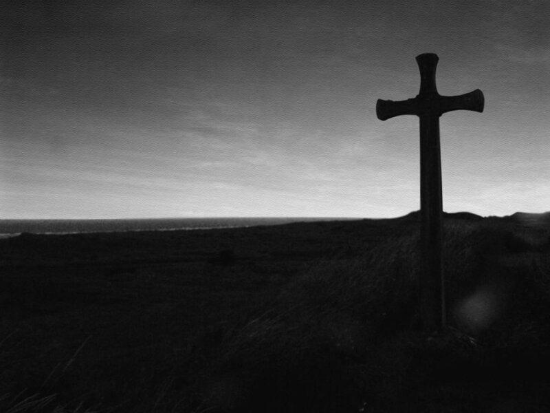 Silhouette of a cross on a hill