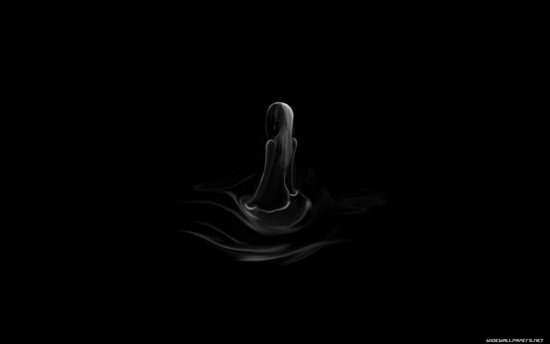 silhouette of a figure in darkness