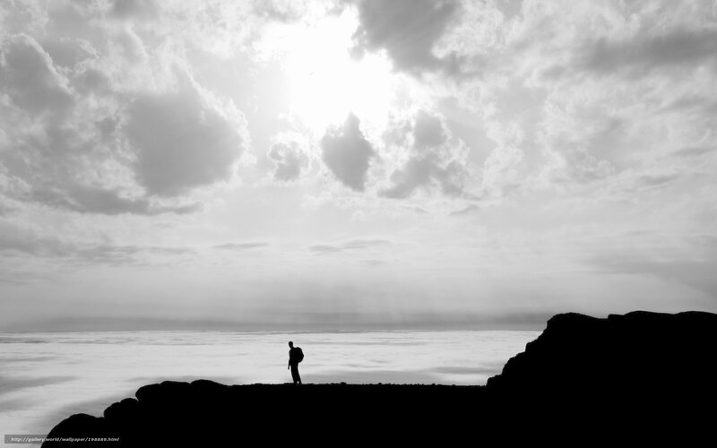 Silhouette of a hiker on a cliff