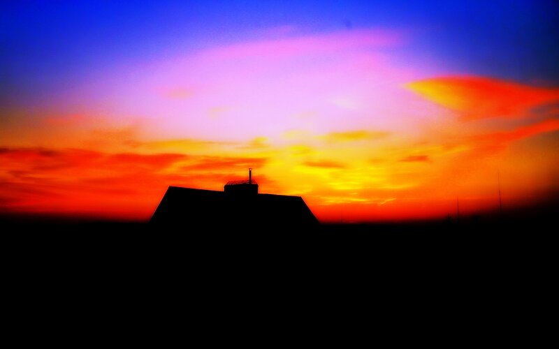 Silhouette of a house at sunset