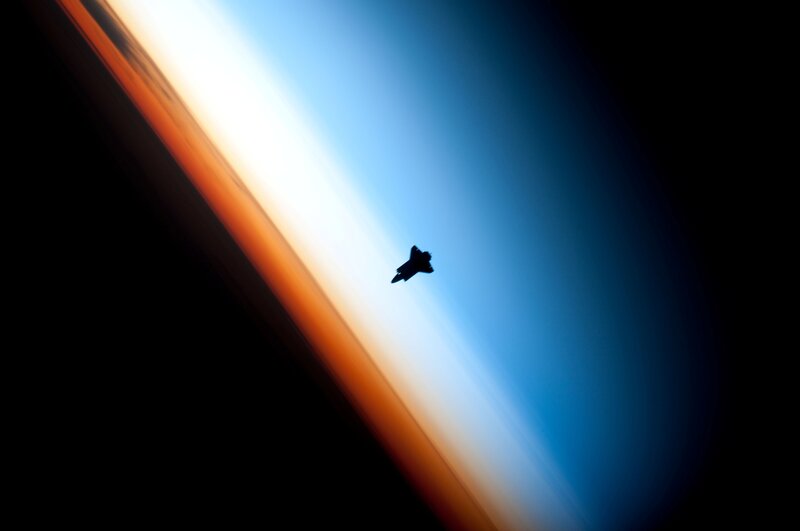 Silhouette of a jet over Earth
