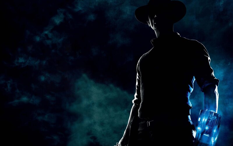 silhouette of a man with glowing device