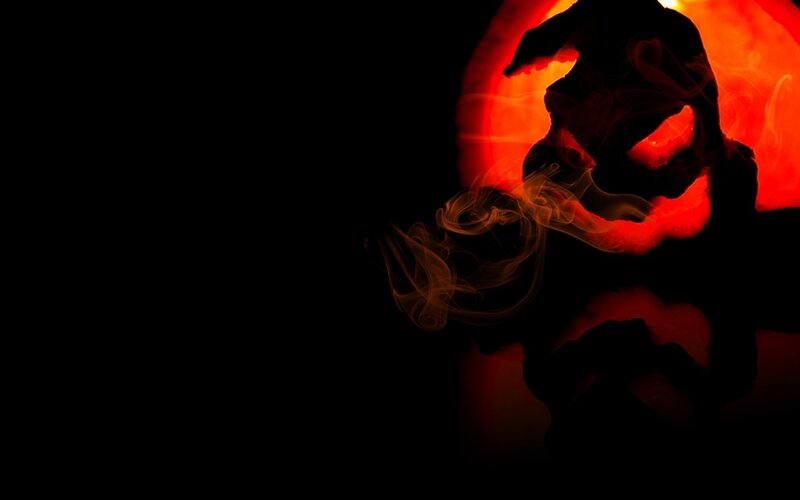 silhouette of a monster in fire