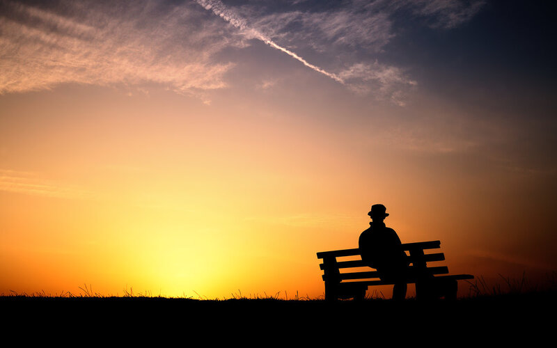 Silhouette of a person on a bench