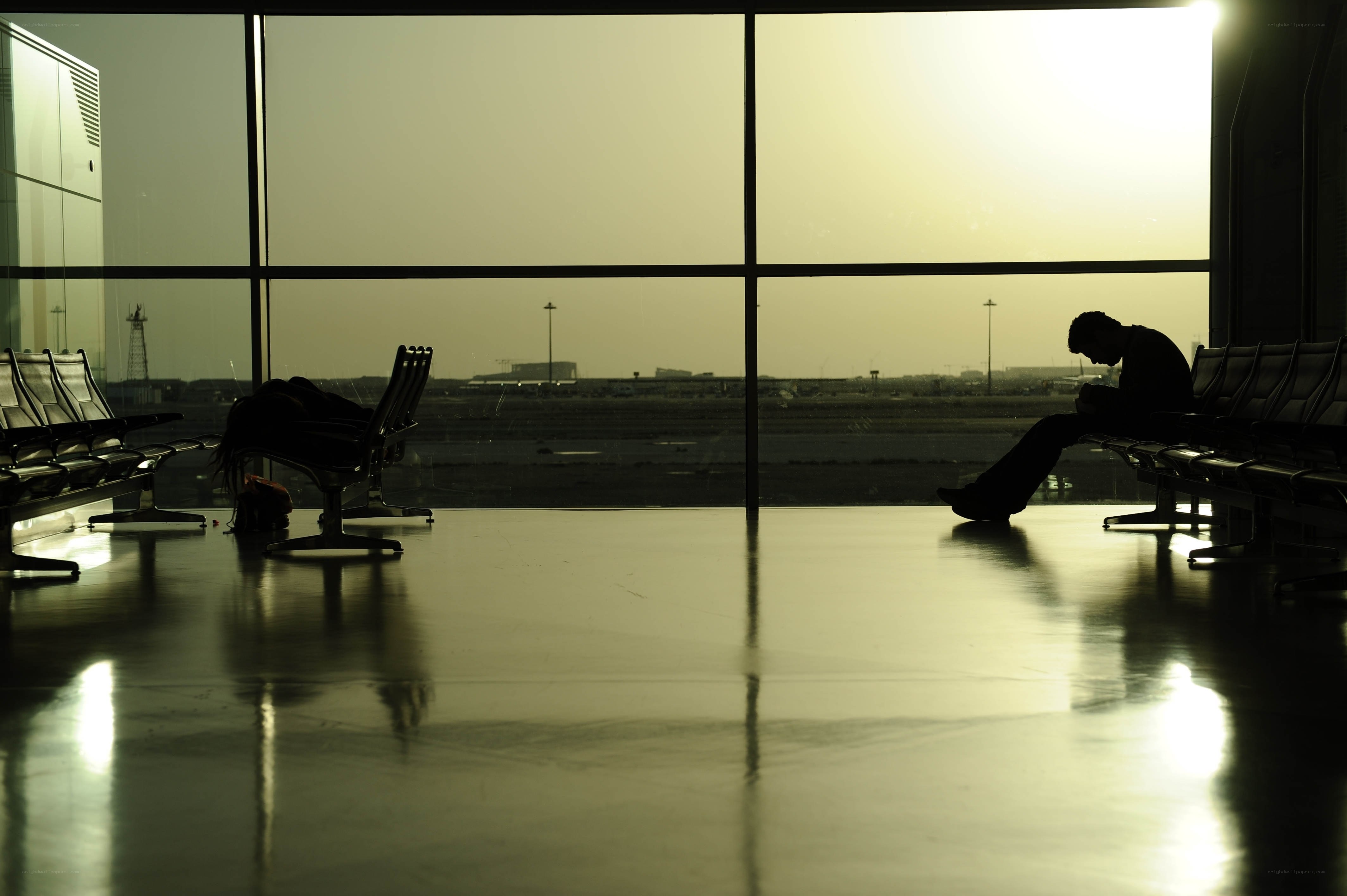 Silhouette of a person waiting at an airport