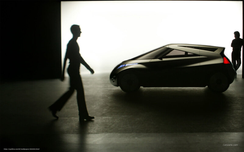 Silhouette of a person walking past a concept car